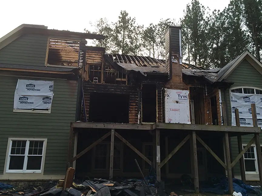 Demolition starts on a fire damaged home.